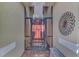 Screened entryway with a red door and decorative wall art at 5229 Canyonland Way, Venice, FL 34293