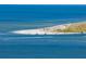Aerial view of a sandy beach with boats and people enjoying a sunny day at 6000 Boca Grande Cswy # D46, Boca Grande, FL 33921