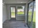 Sunroom with sliding glass doors, a window, and gray flooring at 6829 Anapa Ct, North Port, FL 34287