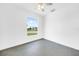 Bright bedroom with large window and ceiling fan at 9262 Genesee St, Port Charlotte, FL 33981