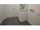 Convenient laundry room with a white cabinet and a utility sink at 9262 Genesee St, Port Charlotte, FL 33981