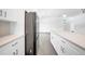 Kitchen features stainless steel refrigerator and white cabinetry at 9262 Genesee St, Port Charlotte, FL 33981