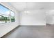 Bright dining room with large window and modern chandelier at 9262 Genesee St, Port Charlotte, FL 33981