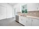 Modern kitchen with white cabinets, quartz countertops, and stainless steel appliances at 9262 Genesee St, Port Charlotte, FL 33981