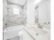 Modern bathroom with marble tile and a white vanity at 9262 Genesee St, Port Charlotte, FL 33981