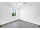 Bedroom with window, ceiling fan, and neutral decor at 9262 Genesee St, Port Charlotte, FL 33981
