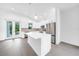 Island kitchen with white cabinets and quartz countertops at 9262 Genesee St, Port Charlotte, FL 33981