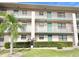 Two-story condo building with balconies and landscaping at 175 Kings Hwy # 233, Punta Gorda, FL 33983