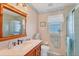 Charming bathroom with a wooden vanity and shower at 64 Long Meadow Ln, Rotonda West, FL 33947