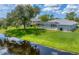 Home with pool and lush green canal-side yard at 64 Long Meadow Ln, Rotonda West, FL 33947