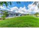 Spacious backyard with lush lawn and canal view at 64 Long Meadow Ln, Rotonda West, FL 33947