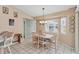 Bright breakfast nook with a table and chairs, overlooking the backyard at 64 Long Meadow Ln, Rotonda West, FL 33947