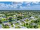 Aerial view of a residential neighborhood with houses and canals at 64 Long Meadow Ln, Rotonda West, FL 33947