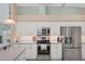 Bright kitchen with stainless steel appliances and white cabinets at 64 Long Meadow Ln, Rotonda West, FL 33947