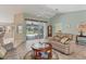 Living room with view of pool and sliders to lanai at 64 Long Meadow Ln, Rotonda West, FL 33947