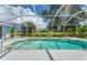 Screened-in pool with a large backyard view at 64 Long Meadow Ln, Rotonda West, FL 33947
