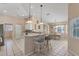 Kitchen with breakfast bar, white cabinets, and stainless steel appliances at 64 Long Meadow Ln, Rotonda West, FL 33947