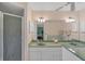Bathroom with double vanity, large mirror, and shower at 64 Long Meadow Ln, Rotonda West, FL 33947
