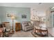 Living area with rocking chair, tiled floors, and access to other rooms at 64 Long Meadow Ln, Rotonda West, FL 33947