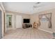 Gathering room with tiled floors, TV, and access to other rooms at 64 Long Meadow Ln, Rotonda West, FL 33947
