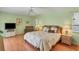 Main bedroom with a king-size bed and wood furniture at 64 Long Meadow Ln, Rotonda West, FL 33947