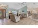Spacious living room with tile floors, vaulted ceilings, and neutral color palette at 64 Long Meadow Ln, Rotonda West, FL 33947