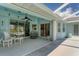 Covered patio with seating area overlooking the pool at 64 Long Meadow Ln, Rotonda West, FL 33947