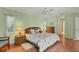 Main bedroom with king bed and access to bathroom at 64 Long Meadow Ln, Rotonda West, FL 33947