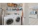 Laundry room with washer, dryer, and shelving at 64 Long Meadow Ln, Rotonda West, FL 33947