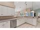 Kitchen with island, white cabinets, and stainless steel appliances at 64 Long Meadow Ln, Rotonda West, FL 33947