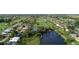 Aerial view of residential community near golf course and waterways at 64 Long Meadow Ln, Rotonda West, FL 33947