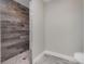 Bathroom with walk-in shower and wood-look tile at 12096 Noel Ave, Port Charlotte, FL 33981