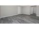 Spacious bedroom with grey wood-look tile flooring and access to hallway at 12043 Richards Ave, Port Charlotte, FL 33981