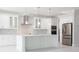 Modern white kitchen with large island and stainless steel appliances at 5240 Willow Lake Ct, Sarasota, FL 34233
