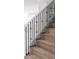 Modern staircase with dark wood treads and black metal railing at 5240 Willow Lake Ct, Sarasota, FL 34233