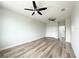 Large bedroom with wood-look flooring, ceiling fans, and double closets at 5240 Willow Lake Ct, Sarasota, FL 34233
