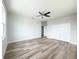 Spacious bedroom featuring wood-look floors and ceiling fan at 5240 Willow Lake Ct, Sarasota, FL 34233