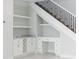 Under-stair built-in cabinetry, shelves, and a desk at 5240 Willow Lake Ct, Sarasota, FL 34233