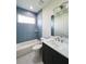 Modern bathroom with blue tile, single vanity, and bathtub at 5240 Willow Lake Ct, Sarasota, FL 34233
