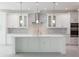 Modern white kitchen with large island and stainless steel appliances at 5240 Willow Lake Ct, Sarasota, FL 34233