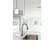 Modern kitchen sink with brushed nickel faucet and white quartz countertop at 5240 Willow Lake Ct, Sarasota, FL 34233