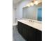 Modern bathroom with dark vanity and marble countertop at 5240 Willow Lake Ct, Sarasota, FL 34233
