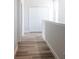 Bright hallway with wood-look flooring and white doors at 5240 Willow Lake Ct, Sarasota, FL 34233