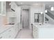 Open concept kitchen with white shaker cabinets, stainless steel appliances, and an island at 5240 Willow Lake Ct, Sarasota, FL 34233