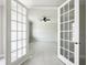 Spacious office with white tile floors and french doors at 5240 Willow Lake Ct, Sarasota, FL 34233
