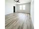 Spacious bedroom with wood-look flooring and two windows at 5240 Willow Lake Ct, Sarasota, FL 34233