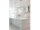 Modern white kitchen with large island and stainless steel appliances at 5240 Willow Lake Ct, Sarasota, FL 34233