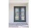 Modern dark gray double front doors with glass panels at 5240 Willow Lake Ct, Sarasota, FL 34233
