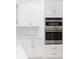 Stainless steel wall oven and microwave combo in a white kitchen at 5240 Willow Lake Ct, Sarasota, FL 34233