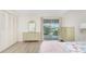 Bedroom with two dressers, a bed, and water view at 3 Quails Run Blvd # 8, Englewood, FL 34223